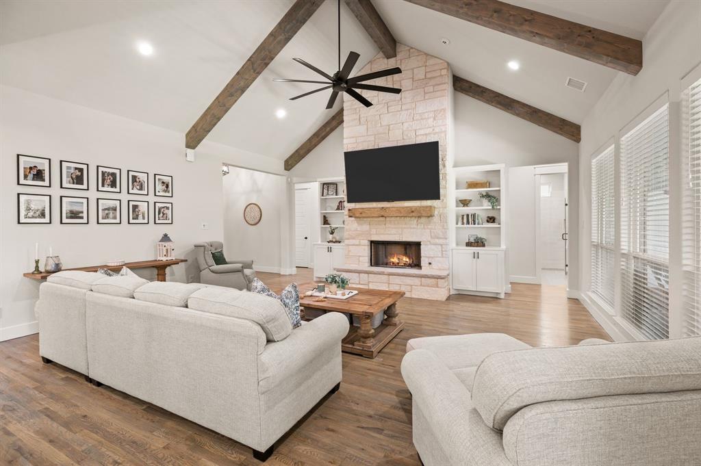 200 Clayton Crossing Springtown, TX 76082 - Photo 7 of 40 a living room with furniture a fireplace and a flat screen tv
