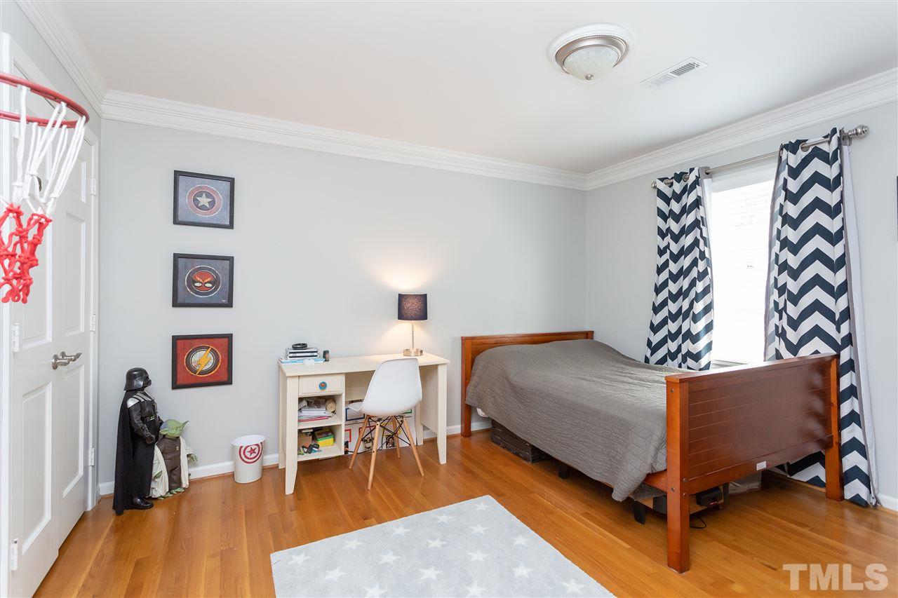 7701 Fiesta Way Raleigh, NC 27615 - Photo 14 of 27 a bedroom with furniture and a wooden floor