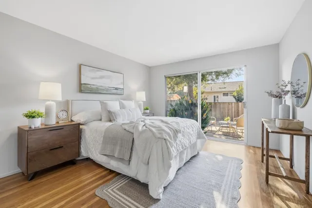 a bedroom with bed and balcony