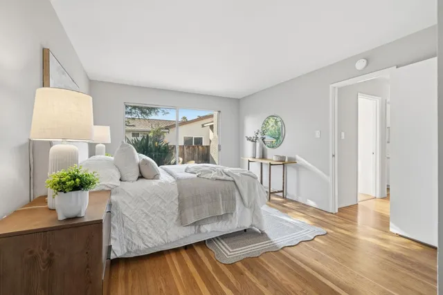 a bedroom with a bed and wooden floor