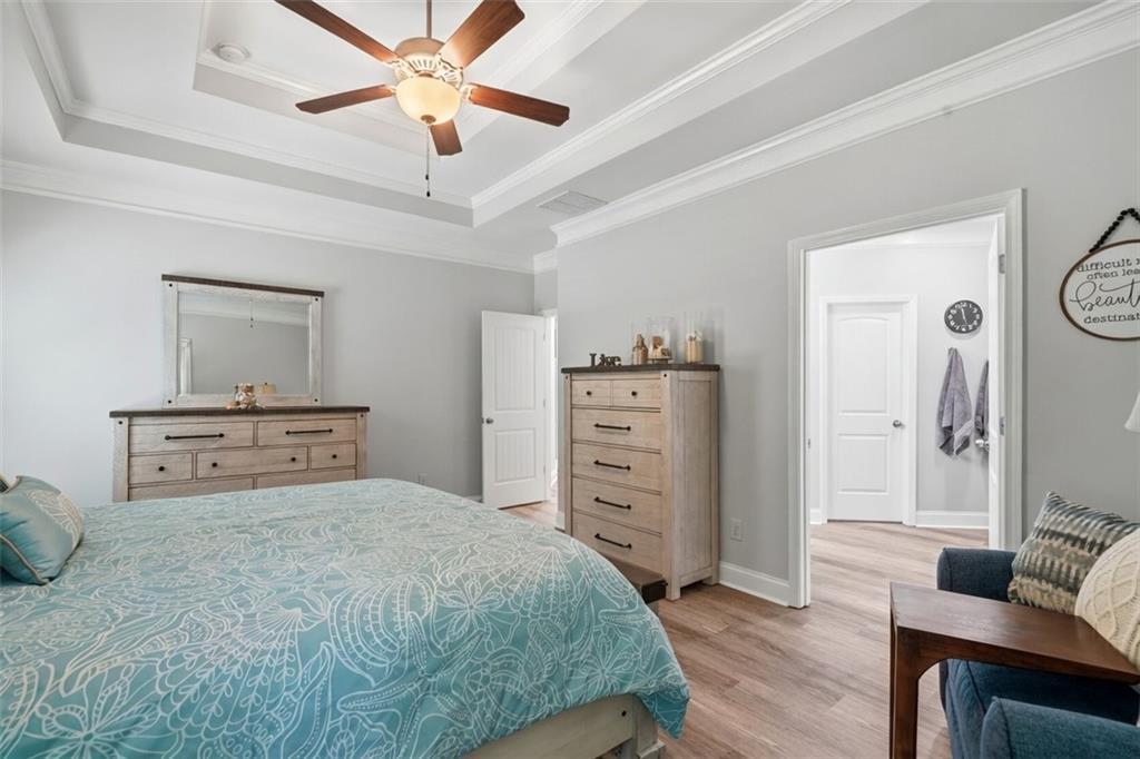 302 Spence Circle Ball Ground, GA 30107 - Photo 24 of 55 a bedroom with a bed and a chandelier