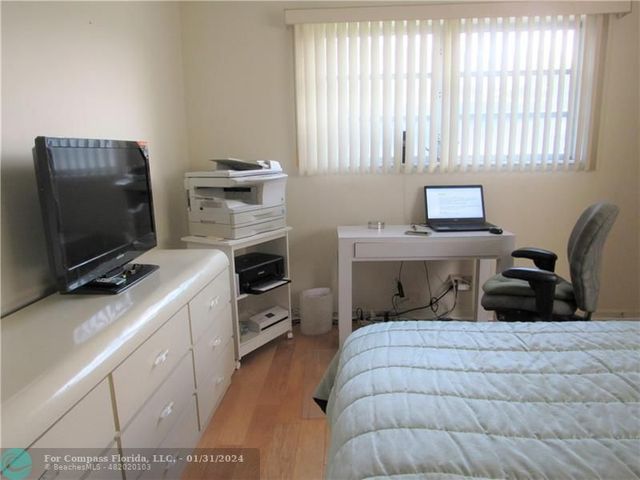 a bedroom with furniture and a flat screen tv