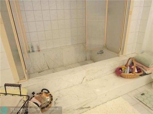 a bathroom with a sink and a shower curtain