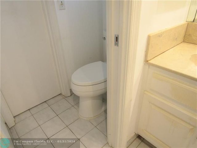 a bathroom with a white toilet and a shower