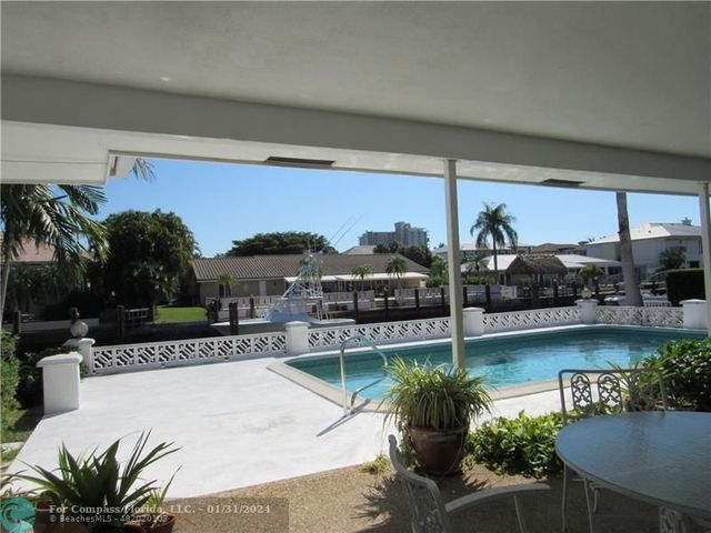 a view of a swimming pool with a patio