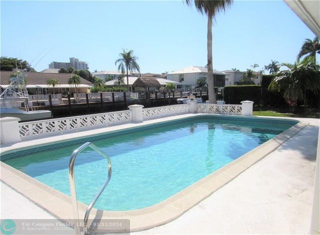 a swimming pool view with a lake view