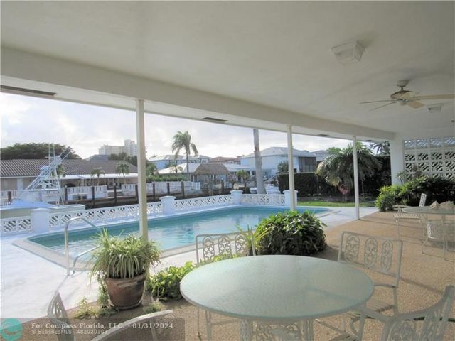 a view of a backyard with garden and patio