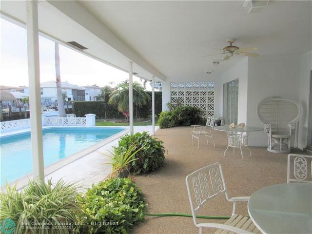a living room filled with furniture and a potted plant