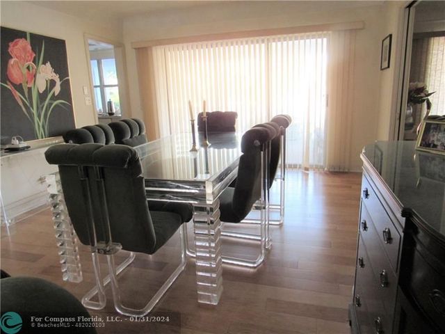 a view of a livingroom with furniture hardwood floor and a window