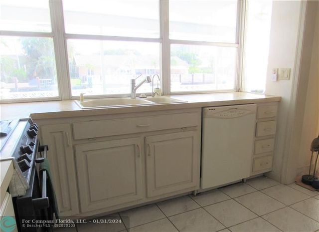 a room with a window and a sink