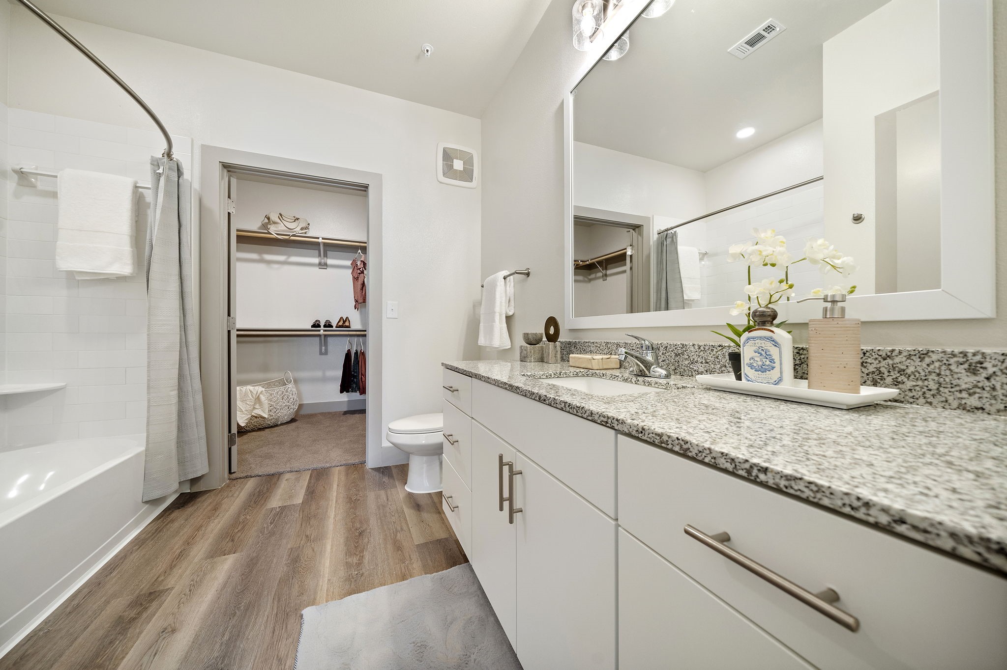 10485 League Line Road, Unit 4206 Conroe, TX 77304 - Photo 7 of 11 a spacious bathroom with a granite countertop sink a toilet a mirror and shower