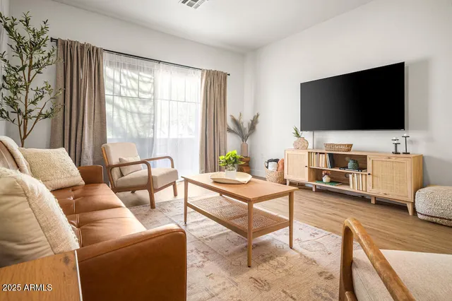 a living room with furniture and a flat screen tv