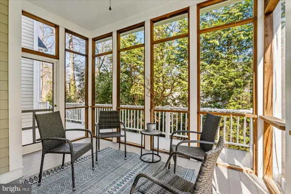 a view of an entryway with wooden floor and door
