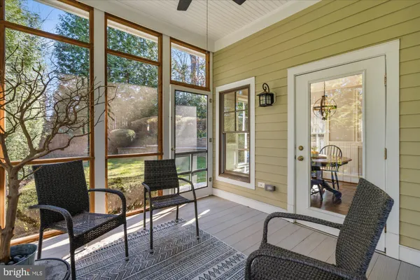 a view of a hallway with wooden floor and entryway