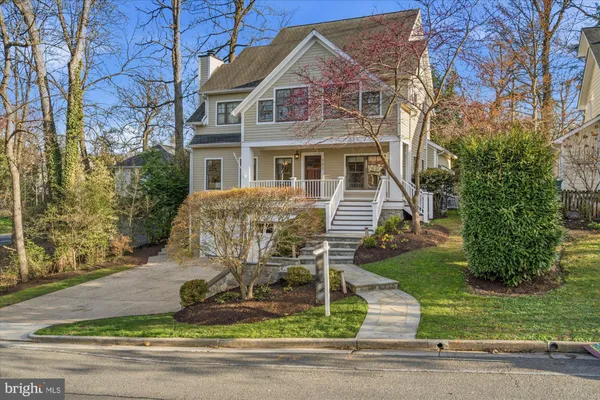 a front view of a house with a yard and outdoor seating