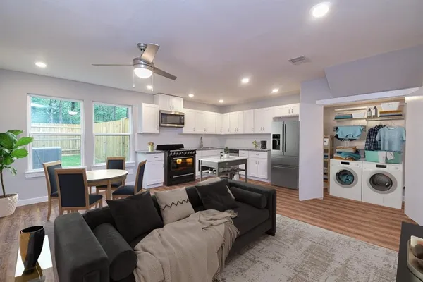 a living room with furniture and a large window