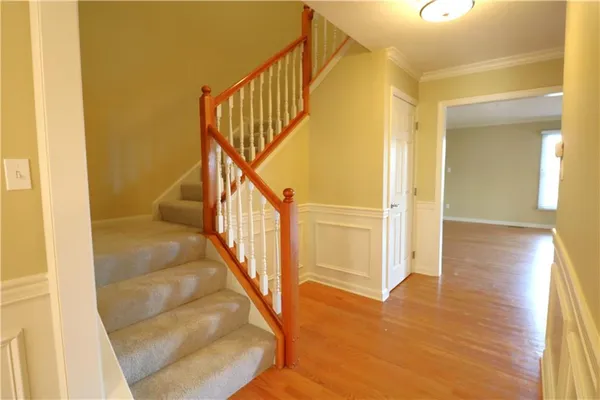 a view of entryway and hall with wooden floor