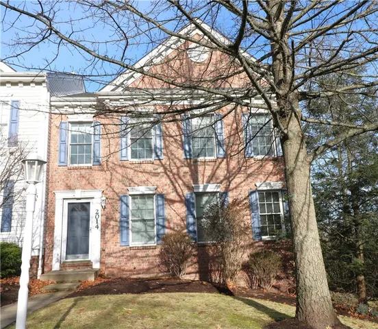 a view of a building with a large tree