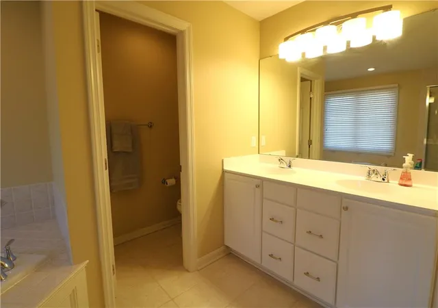 a bathroom with double sink and a mirror