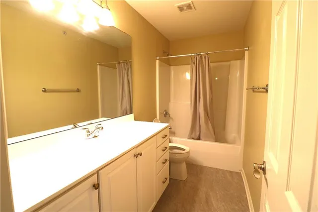 a view of an empty room and a window