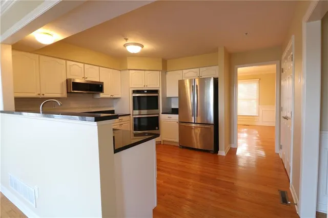 a kitchen with granite countertop a refrigerator and a sink