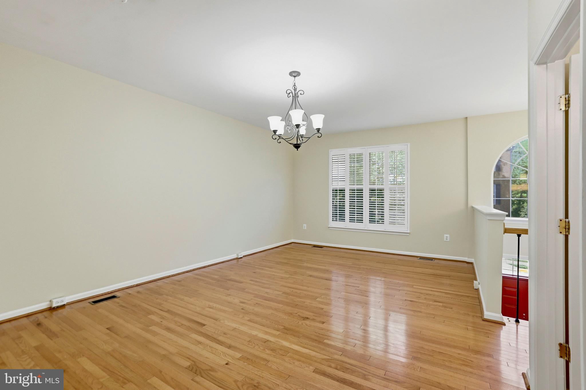 21648 Frame Square Broadlands, VA 20148 - Photo 7 of 36 a view of an empty room with wooden floor and a window