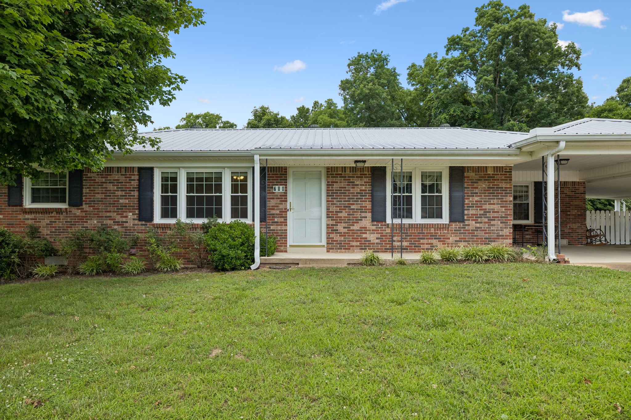 708 Hickory Street Centerville, TN 37033 - Photo 4 of 57 a backyard of a house with potted plants and large tree