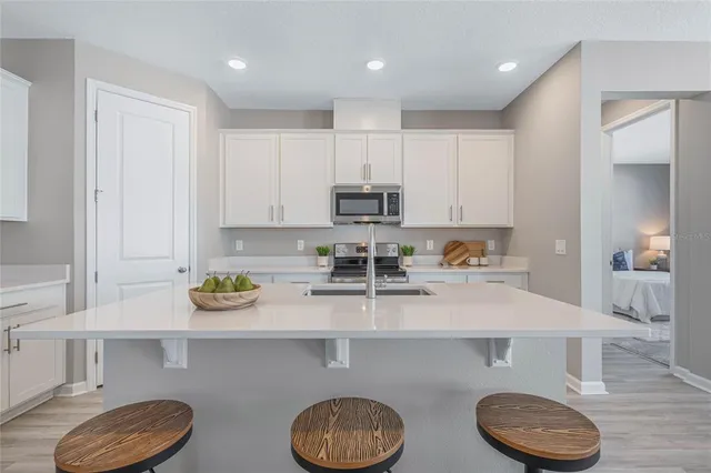a kitchen with a sink a stove and cabinets