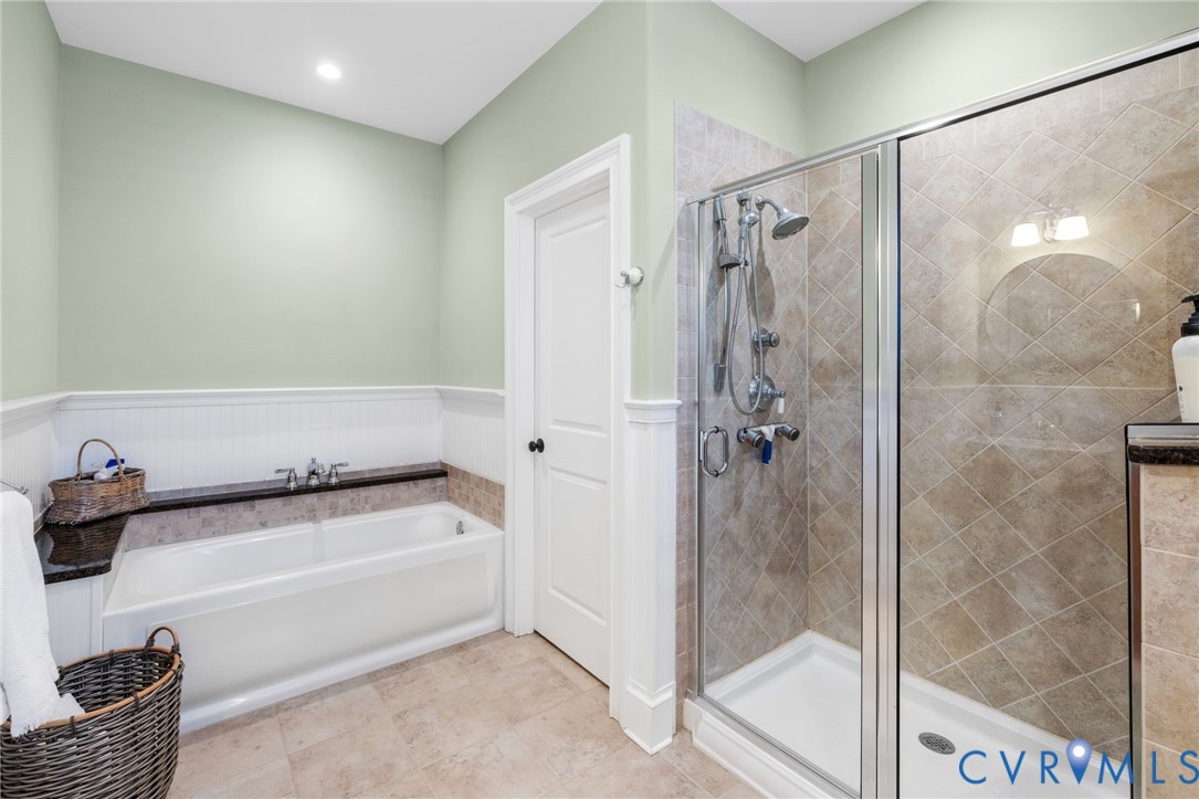 8947 Cherokee Road Richmond, VA 23235 - Photo 27 of 45 a bathroom with a bathtub and a shower