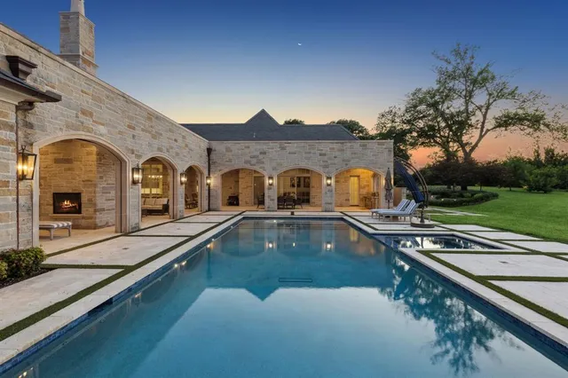 a view of a house with swimming pool and a porch