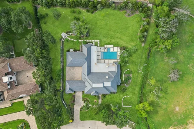an aerial view of a house with a yard and lake view