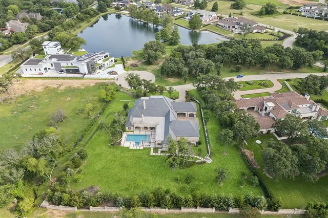 an aerial view of residential houses with outdoor space and street view