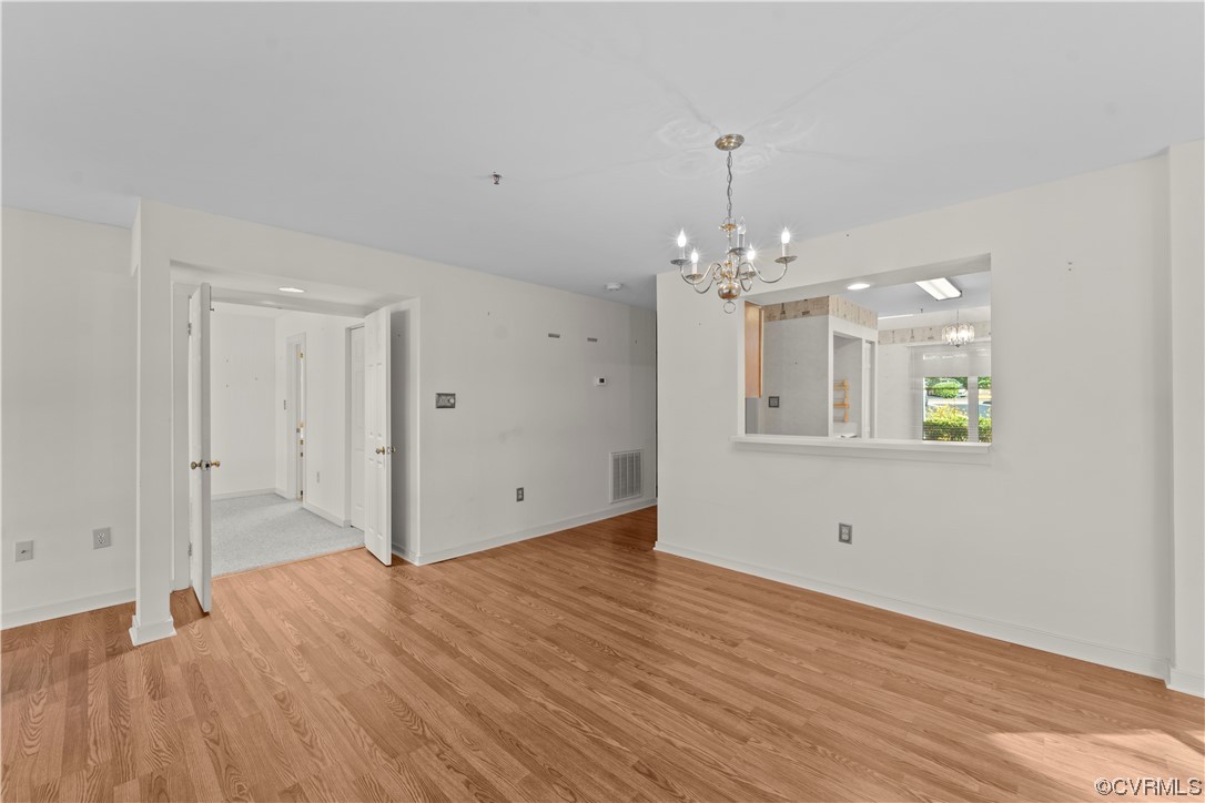 126 Water Pointe Court Midlothian, VA 23112 - Photo 8 of 19 a view of a hallway with wooden floor and chandelier