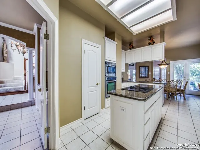 a kitchen with stainless steel appliances granite countertop a stove and a refrigerator