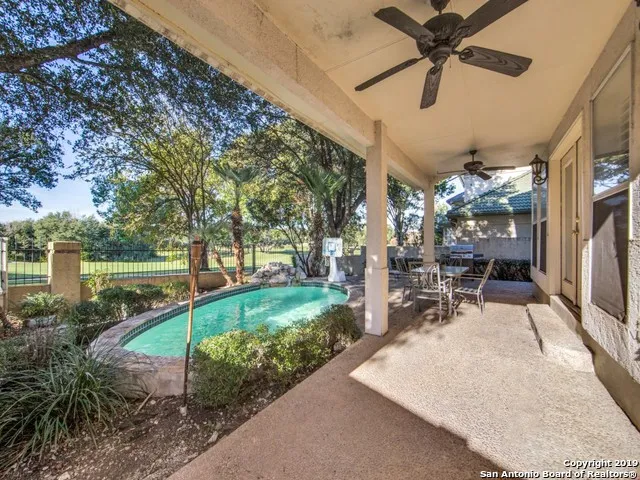 a view of a porch with chairs and backyard
