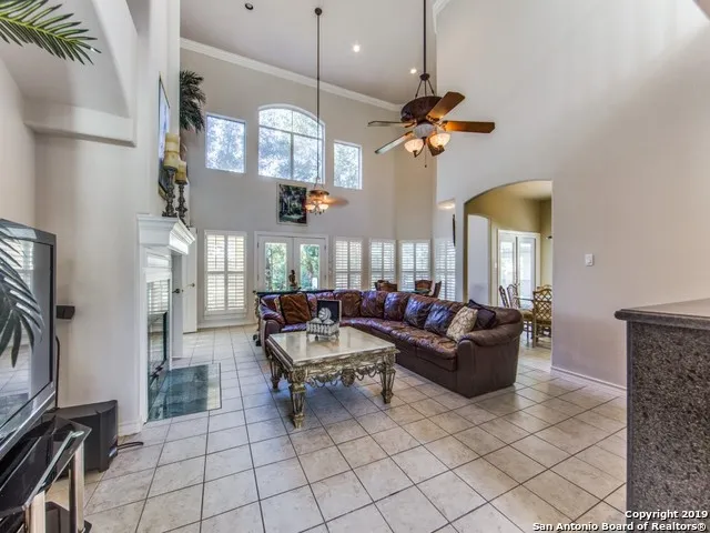 a living room with fireplace furniture and a flat screen tv