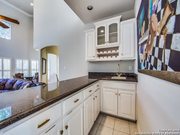 a kitchen with stainless steel appliances granite countertop a sink and cabinets