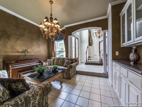 a lobby with furniture and a chandelier