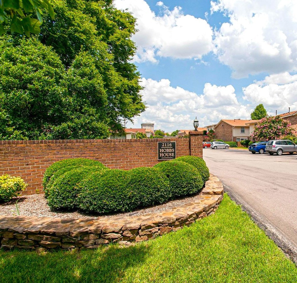 a view of a street with a cars park side of the road
