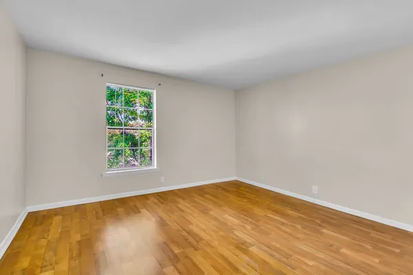 a bedroom with a bed and a potted plant