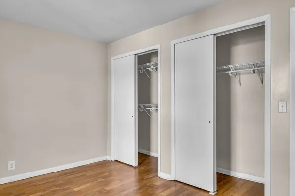 a view of an empty room and wooden floor