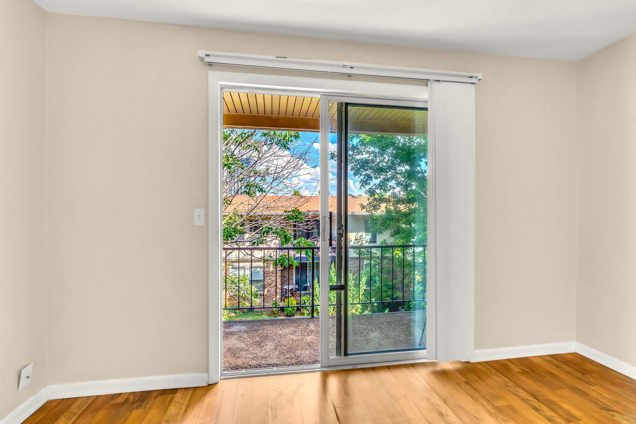 2116 Hobbs Road, Unit N19 Nashville, TN 37215 - Photo 26 of 33 a view of an empty room with wooden floor and a window