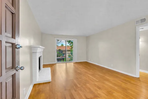 a living room with furniture potted plant and a fireplace
