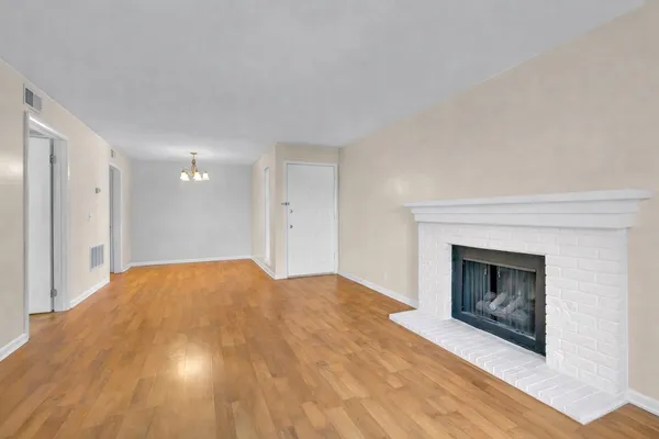 a view of a livingroom with a fireplace and chandelier fan