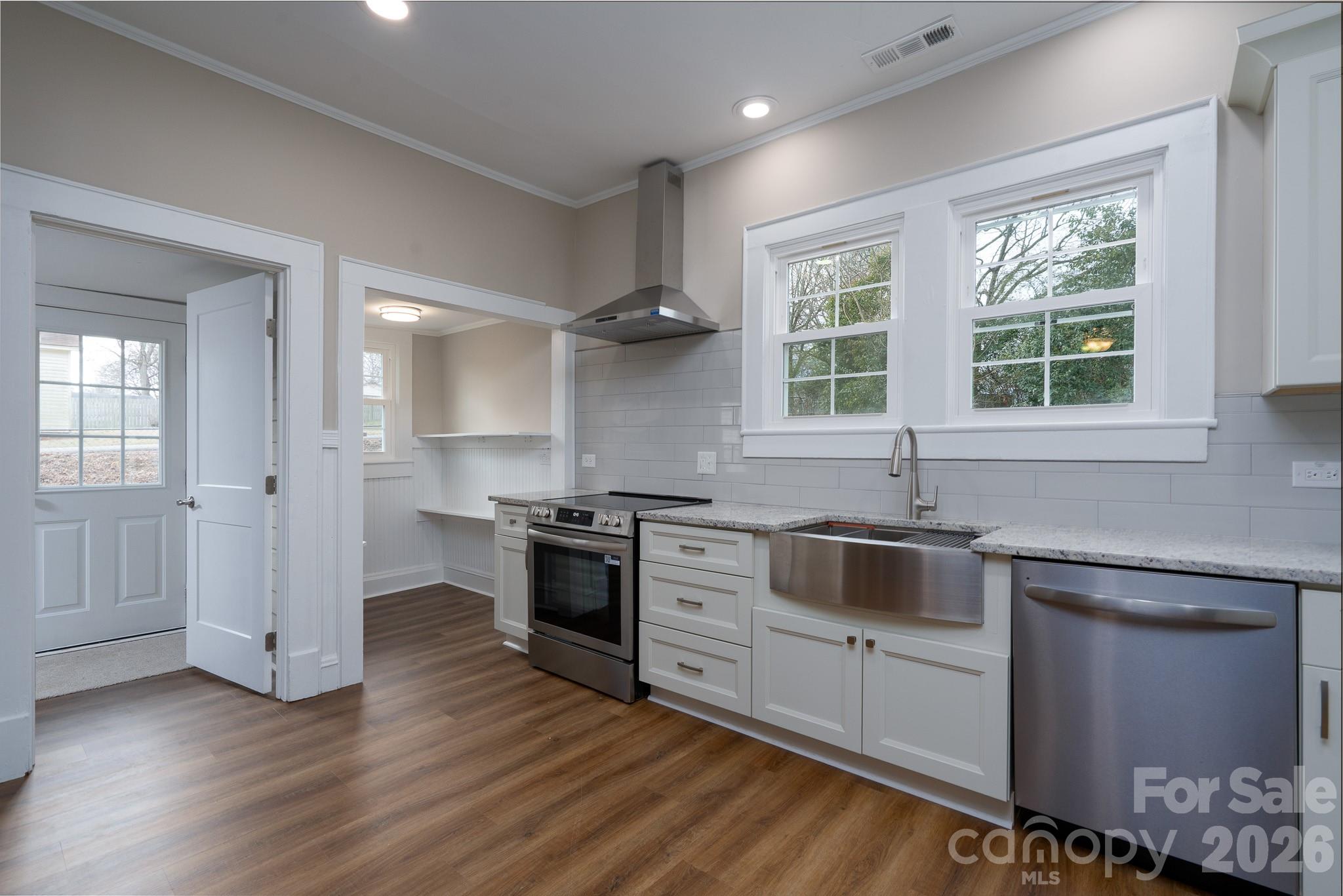 61 3rd Street Northwest Concord, NC 28027 - Photo 12 of 40 a kitchen with a stove and a sink