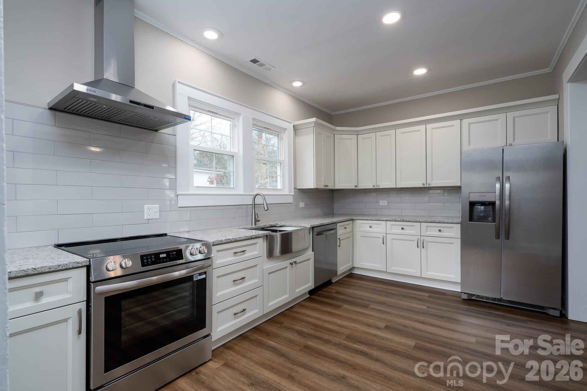 61 3rd Street Northwest Concord, NC 28027 - Photo 14 of 40 a kitchen with granite countertop cabinets stainless steel appliances and a window