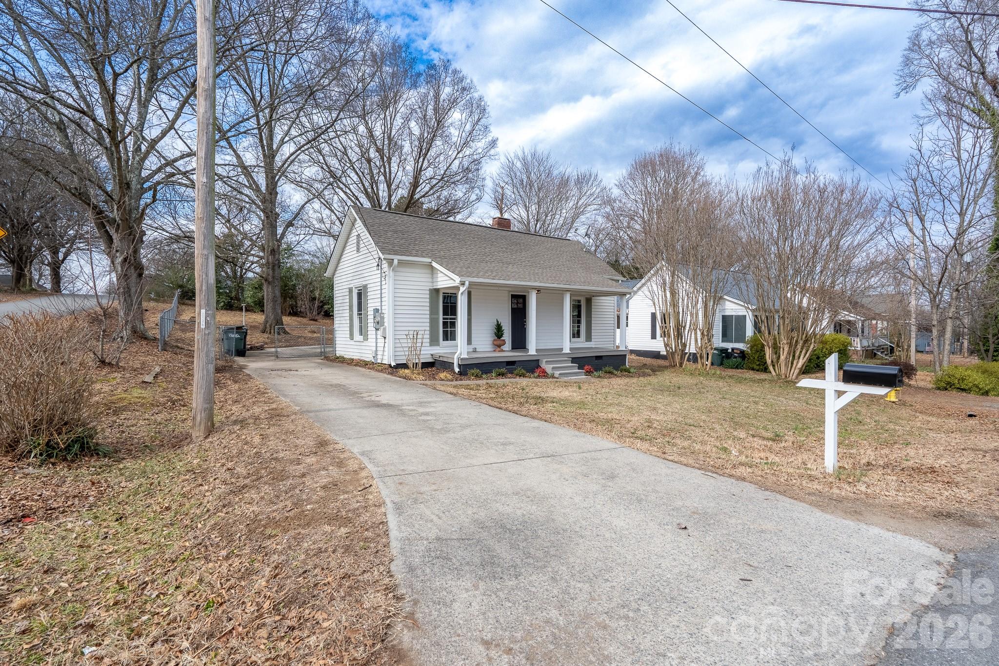 61 3rd Street Northwest Concord, NC 28027 - Photo 32 of 40 a front view of a house with a yard covered with snow