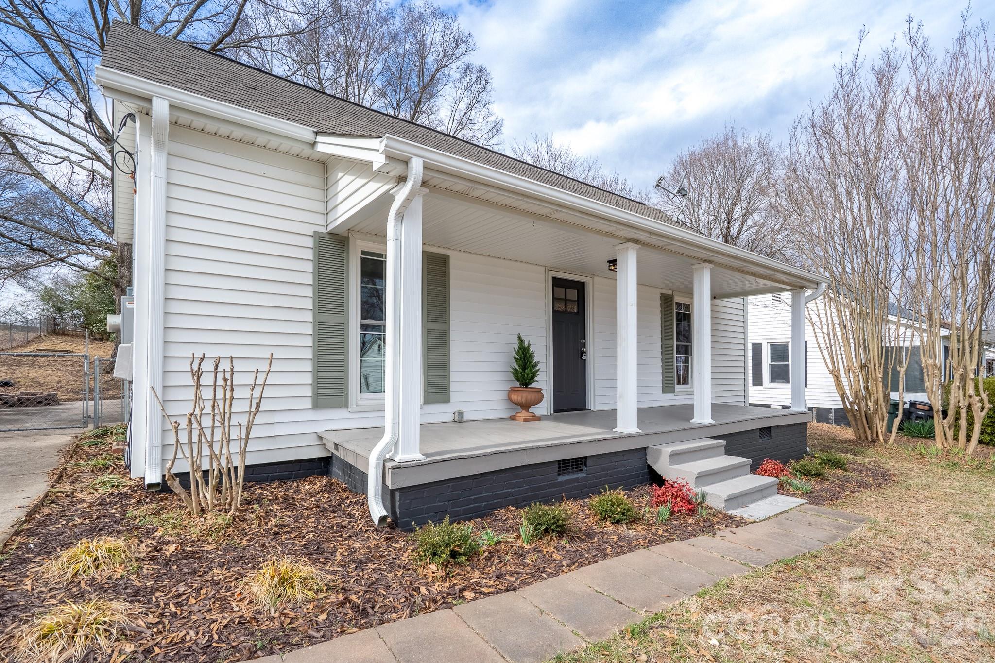61 3rd Street Northwest Concord, NC 28027 - Photo 34 of 40 a front view of a house with garden