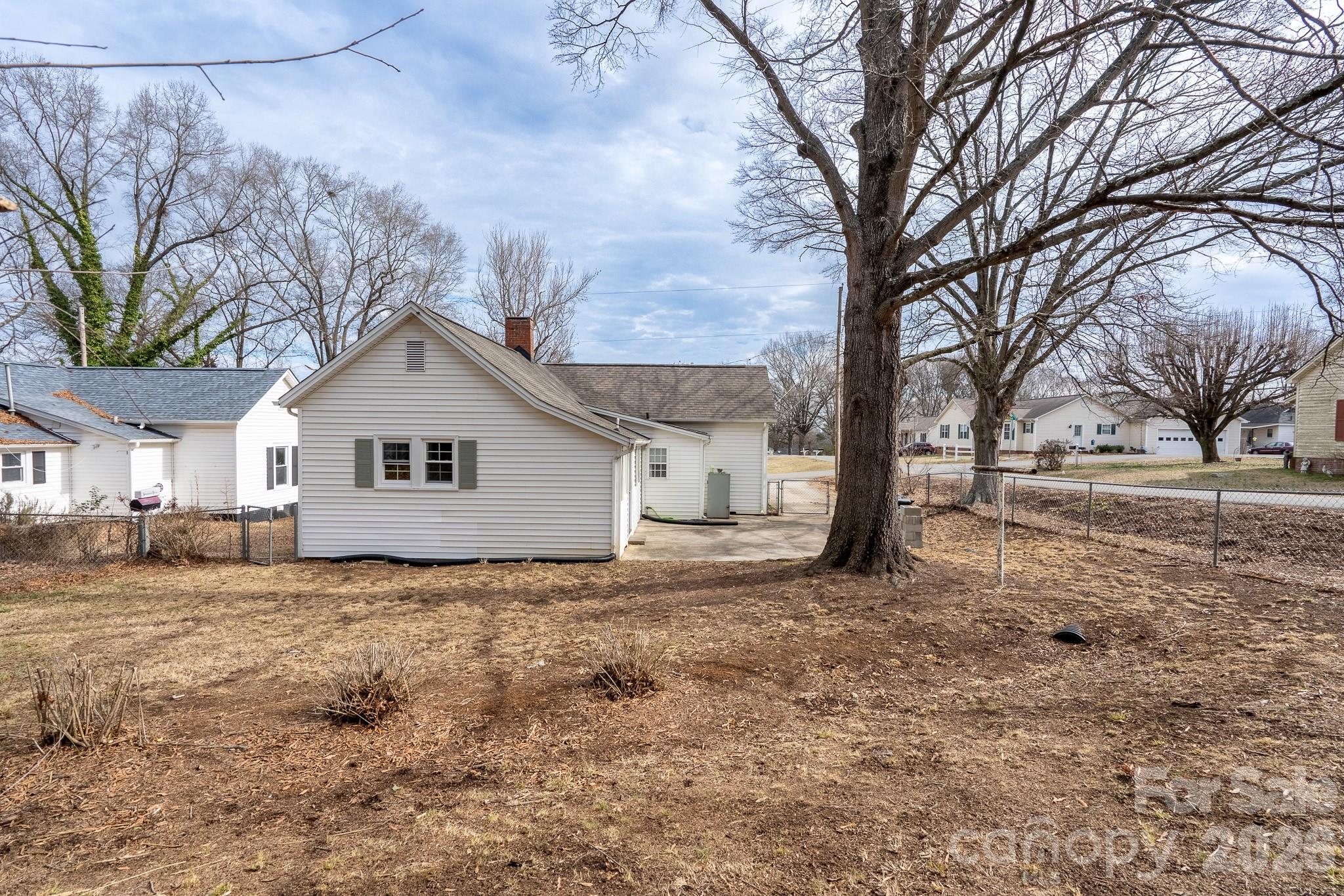 61 3rd Street Northwest Concord, NC 28027 - Photo 36 of 40 a white house that has a tree in front of it