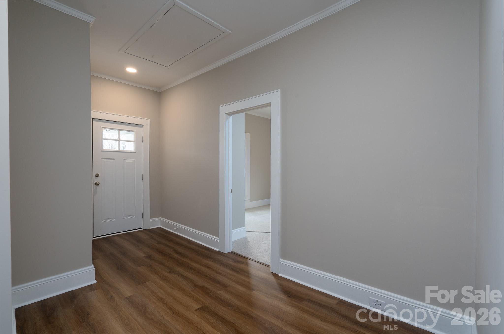 61 3rd Street Northwest Concord, NC 28027 - Photo 4 of 40 a view of an empty room with wooden floor and a window